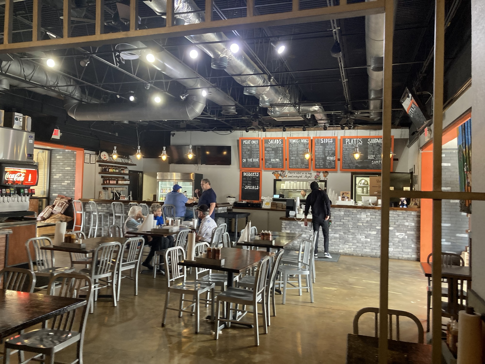 A shot from the back of the restaurant gives a full view of the seating area, with the front counter in the background.