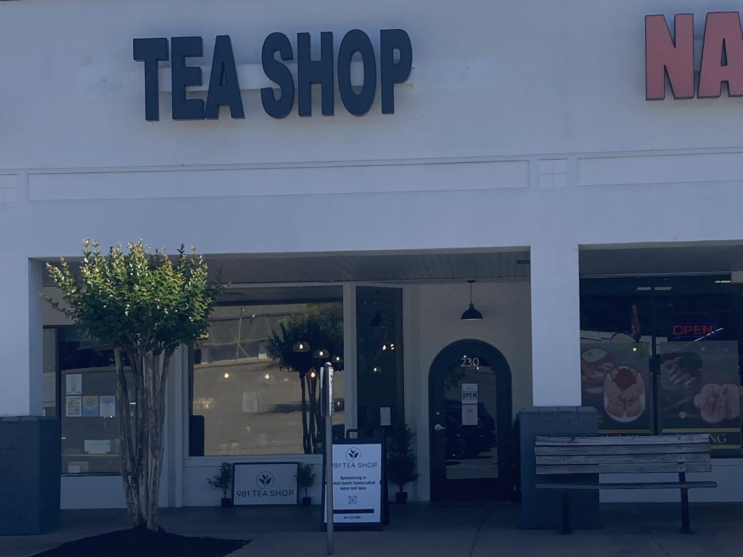 A part of a strip mall includes Tea Shop